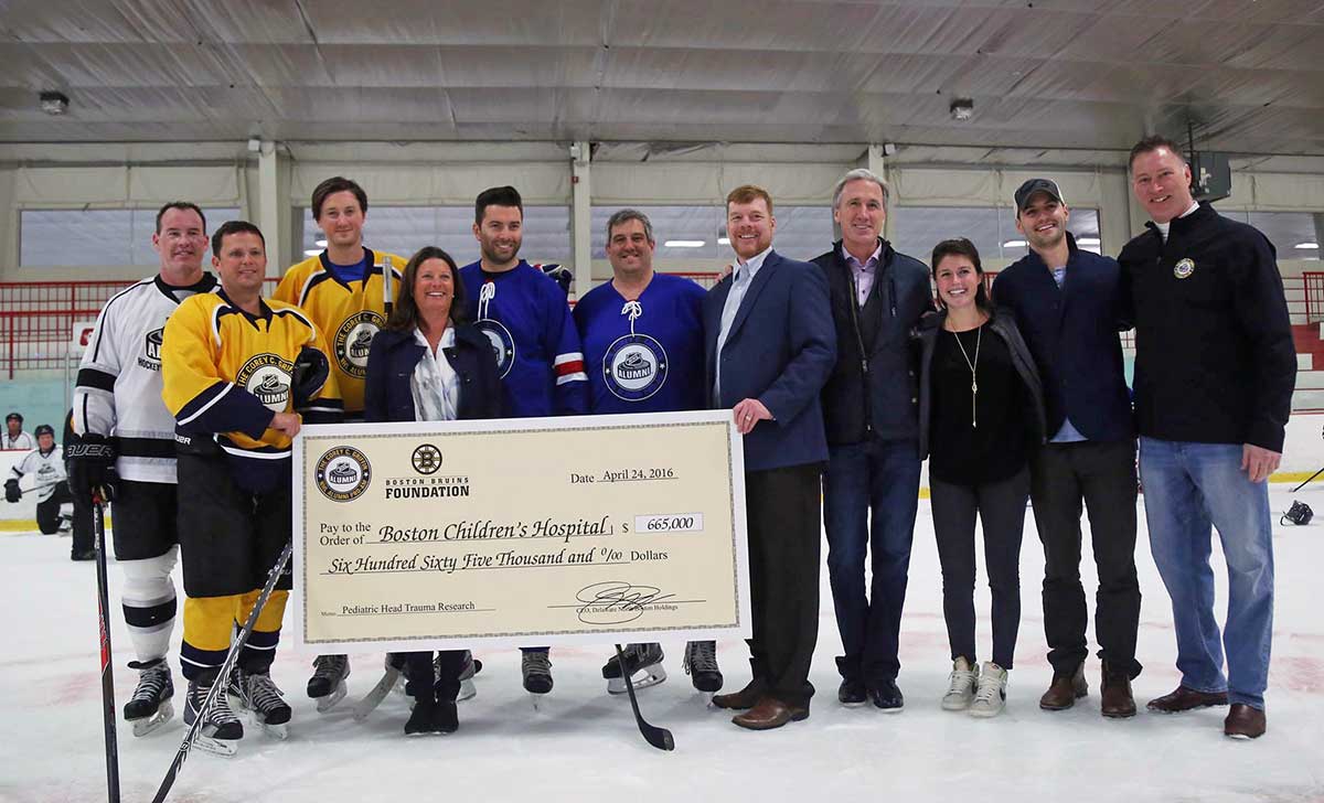 Team Blue blood AI captain Jay Corrigan (second from left) with draft pick Ray Bourque (second from right) and NHL Pro-Am founder Mike Griffin (at right)